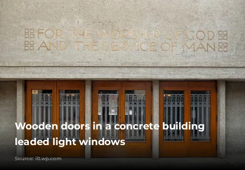 Wooden doors in a concrete building with leaded light windows