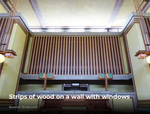 Strips of wood on a wall with windows above