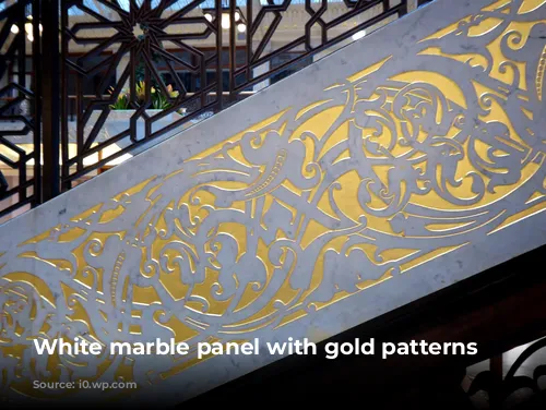 White marble panel with gold patterns engraved