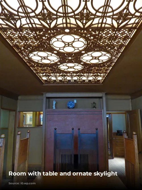 Room with table and ornate skylight