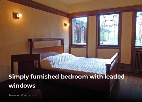 Simply furnished bedroom with leaded light windows