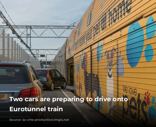 Two cars are preparing to drive onto a Eurotunnel train