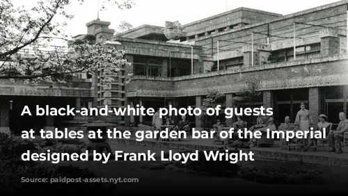 A black-and-white photo of guests seated at tables at the garden bar of the Imperial Hotel designed by Frank Lloyd Wright
