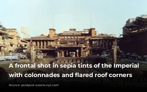 A frontal shot in sepia tints of the Imperial Hotel with colonnades and flared roof corners 
