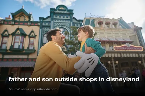 father and son outside shops in disneyland paris