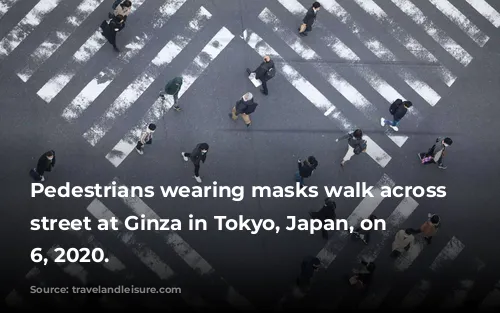 Pedestrians wearing masks walk across the street at Ginza in Tokyo, Japan, on March 6, 2020.