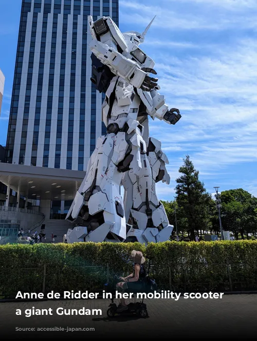 Anne de Ridder in her mobility scooter with a giant Gundam