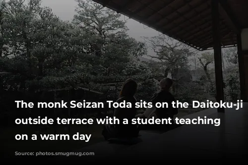 The monk Seizan Toda sits on the Daitoku-ji temple’s outside terrace with a student teaching zazen on a warm day