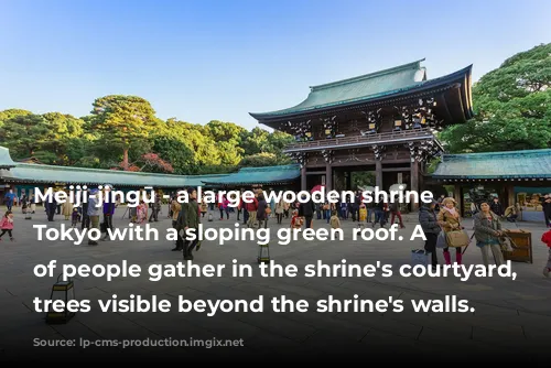 Meiji-jingū - a large wooden shrine in Tokyo with a sloping green roof. A crowd of people gather in the shrine's courtyard, with trees visible beyond the shrine's walls.