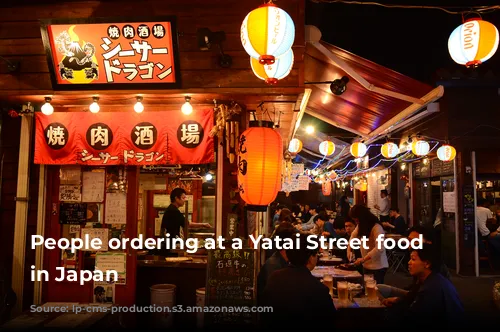 People ordering at a Yatai Street food vendor in Japan