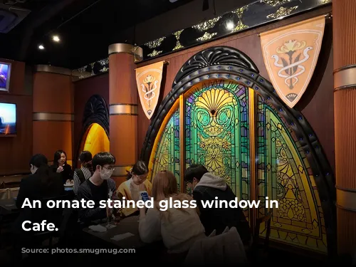 An ornate stained glass window in Eorzea Cafe.