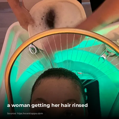 a woman getting her hair rinsed