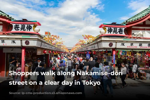 Shoppers walk along Nakamise-dōri shopping street on a clear day in Tokyo