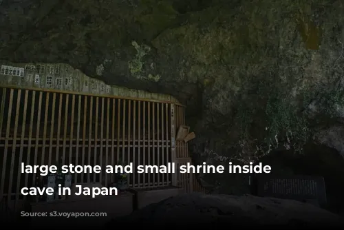 large stone and small shrine inside Reigando cave in Japan