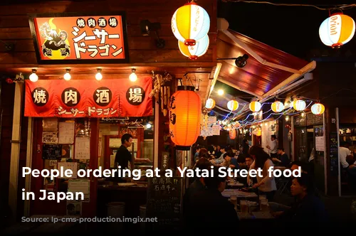 People ordering at a Yatai Street food vendor in Japan