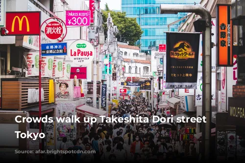 Crowds walk up Takeshita Dori street in Tokyo