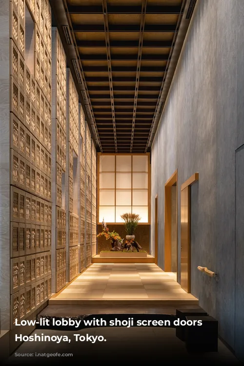 Low-lit lobby with shoji screen doors in Hoshinoya, Tokyo.