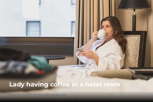 Lady having coffee in a hotel room 