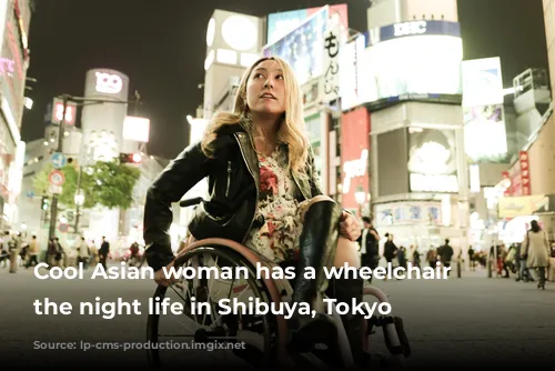 Cool Asian woman has a wheelchair enjoy the night life in Shibuya, Tokyo