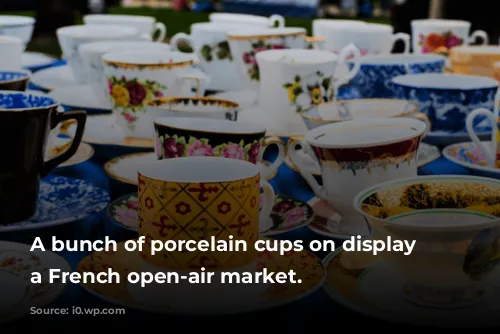 A bunch of porcelain cups on display at a French open-air market.