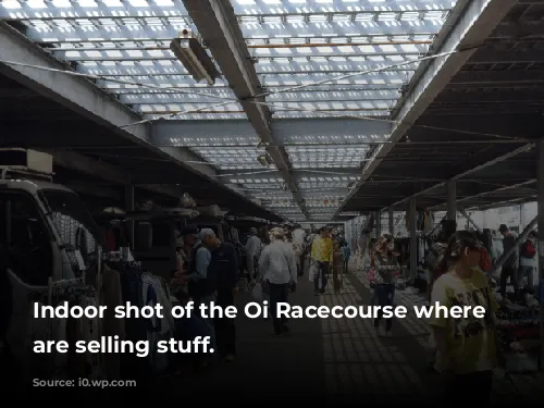 Indoor shot of the Oi Racecourse where people are selling stuff.