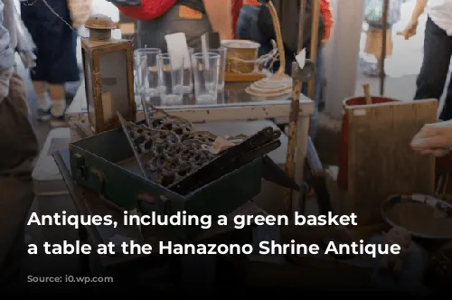 Antiques, including a green basket on a table at the Hanazono Shrine Antique Market.