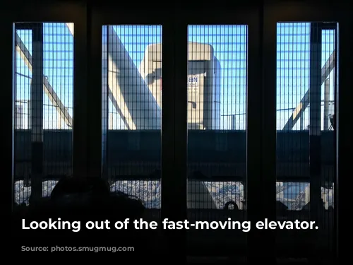 Looking out of the fast-moving elevator.