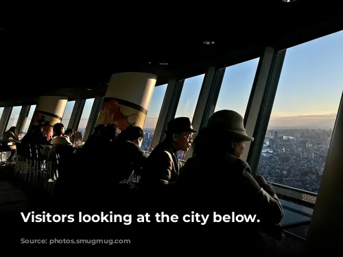 Visitors looking at the city below.