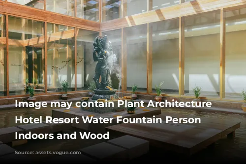 Image may contain Plant Architecture Building Hotel Resort Water Fountain Person Cup Indoors and Wood