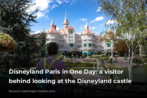 Disneyland Paris in One Day: a visitor from behind looking at the Disneyland castle