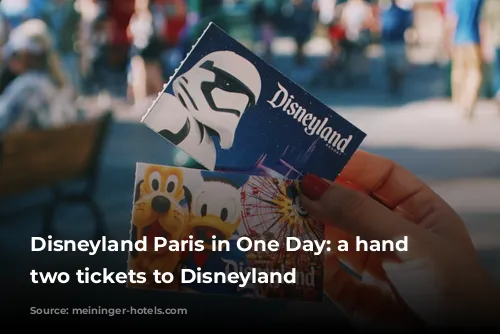 Disneyland Paris in One Day: a hand holding two tickets to Disneyland