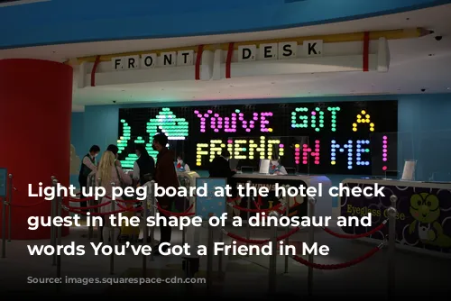  Light up peg board at the hotel check in guest in the shape of a dinosaur and the words You’ve Got a Friend in Me 